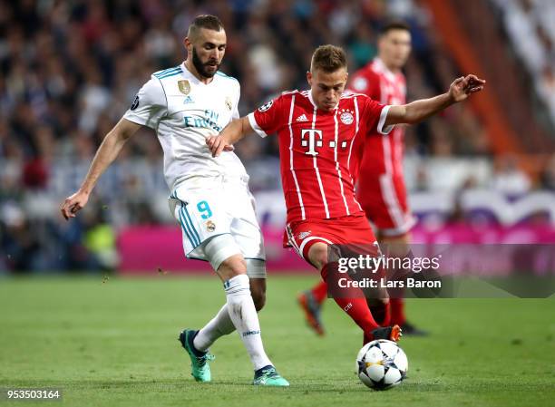 Joshua Kimmich of Bayern Muenchen holds off Karim Benzema of Real Madrid during the UEFA Champions League Semi Final Second Leg match between Real...