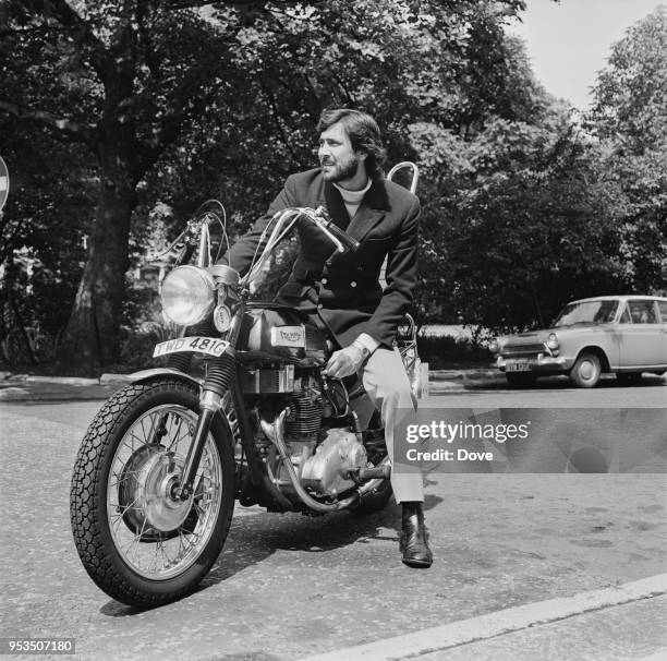 Australian actor and former model George Lazenby on his motorcycle, UK, 27th July 1970.