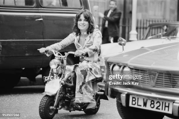 British peer Emma Chetwode riding a 50cc Honda Monkey motorcycle on her way to work, Soho, London, UK, 25th June 1970.