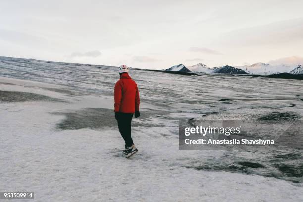 man in helmet exploring vatnajokull glacier - breidamerkurjokull glacier stock pictures, royalty-free photos & images