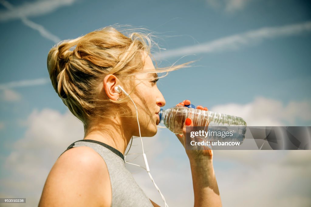 Jogger in the park drinking