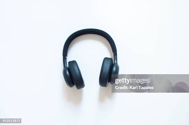 a top view of a black headphones - headphones white background stock pictures, royalty-free photos & images