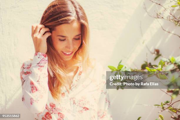 pretty woman looking down at the garden - down blouse imagens e fotografias de stock