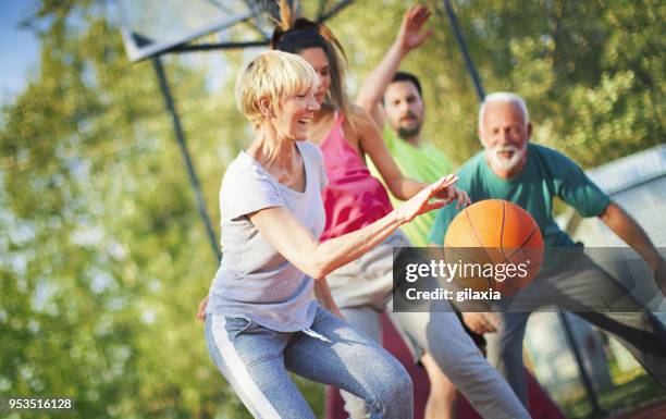 basketball game with family. - outside basketball hoops stock pictures, royalty-free photos & images