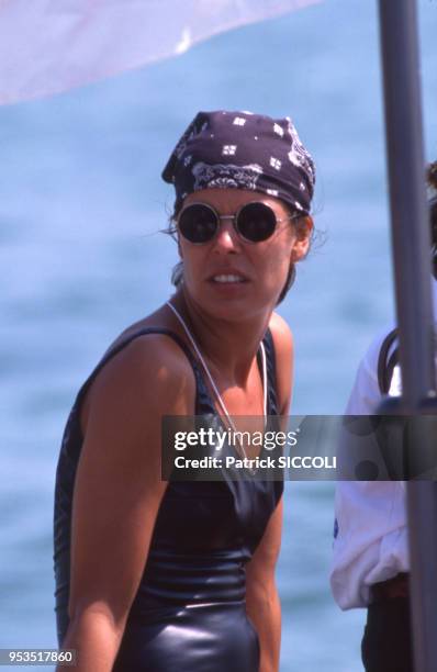 La princesse Caroline de Monaco à bord d'un bateau en maillot de bain avec des lunettes de soleil et un bandana le 1er août 1988 à Monaco.