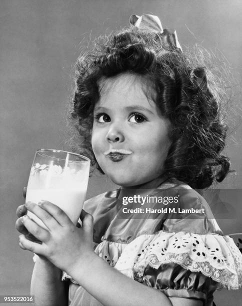 CLOSE-UP OF GIRL DRINKING MILK