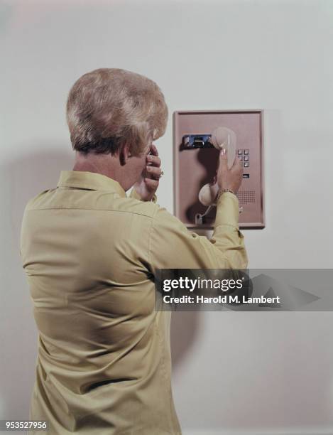 WOMAN HOLDING TELEPHONE RECEIVER