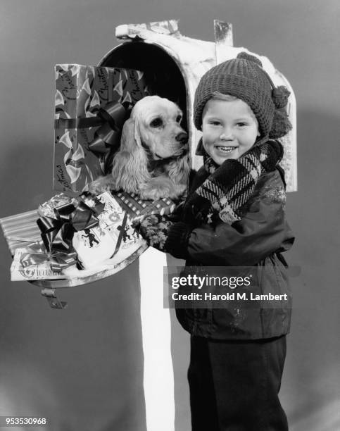 BOY STANDING NEXT TO MAILBOX, SMILING