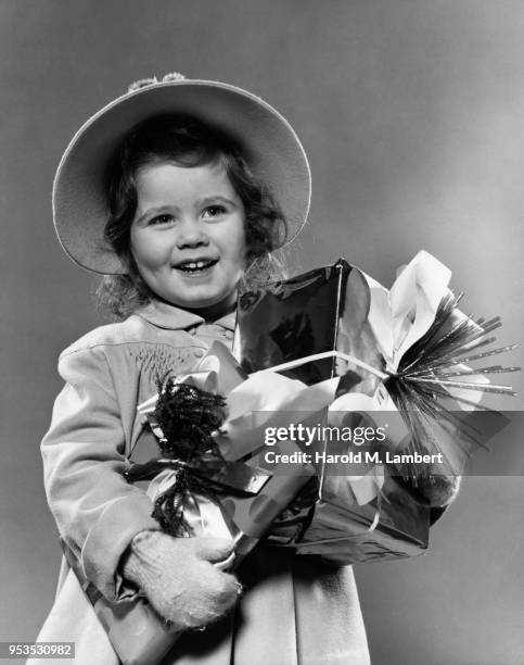 GIRL HOLDING CHRISTMAS PRESENTS