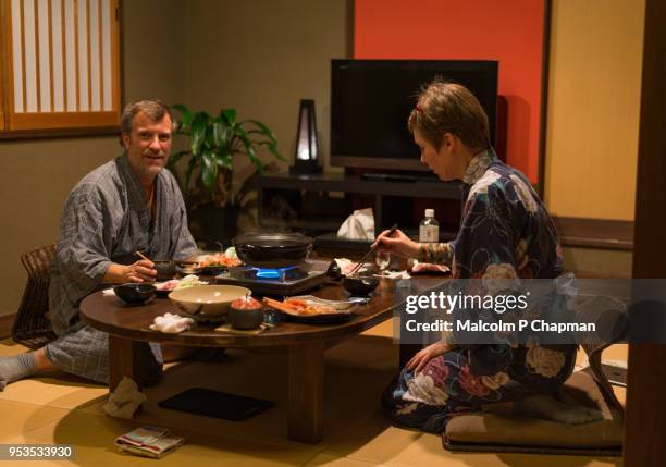 tourists in yukata enjoy kaiseki meal in ryokan - ryokan foto e immagini stock