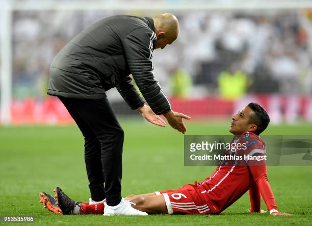 Thiago Alcantara of Bayern Muenchen is consoled by Arjen Robben of Bayern Muenchen as they fail to reach the final after the UEFA Champions League...