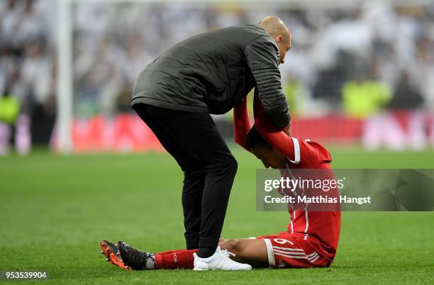 Thiago Alcantara of Bayern Muenchen is consoled by Arjen Robben of Bayern Muenchen as they fail to reach the final after the UEFA Champions League...