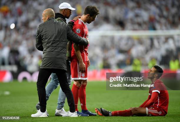 Thiago Alcantara of Bayern Muenchen is consoled by Arjen Robben, Jerome Boateng and Javi Martinez of Bayern Muenchen as they fail to reach the final...