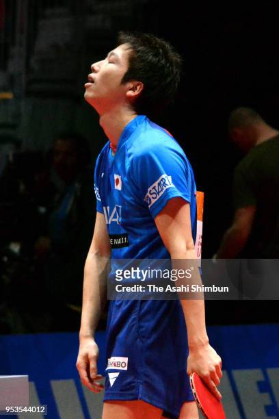 Jun Mizutani of Japan reacts after losing a point against Liam Pitchford of England in the Men's Group C match between Japan and England on day two...
