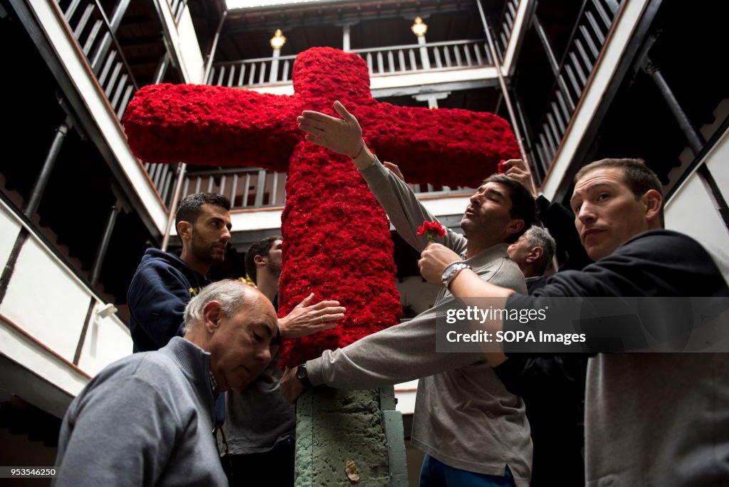 Men in the "Corrala de Santiago" try to put up the cross...