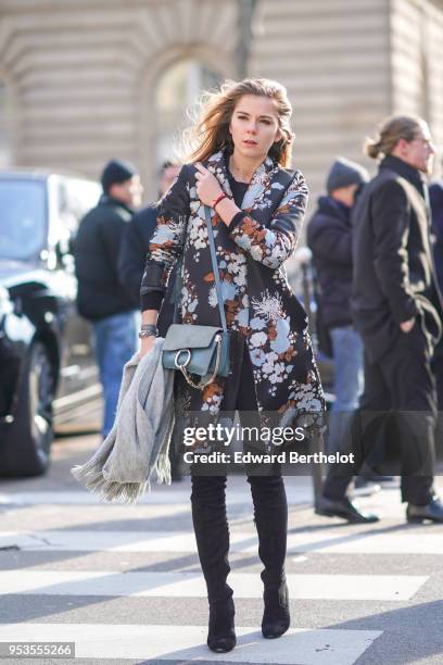 Guest wears a flower print jacket, a Chloe bag, black boots, during Paris Fashion Week Womenswear Fall/Winter 2018/2019, on February 28, 2018 in...