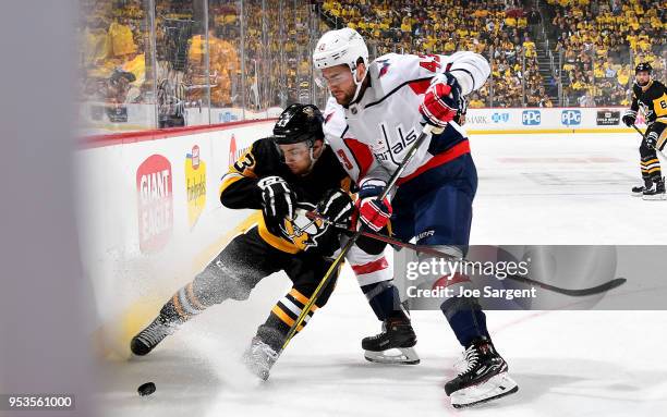 Tom Wilson of the Washington Capitals and Conor Sheary of the Pittsburgh Penguins battle for the puck in Game Three of the Eastern Conference Second...