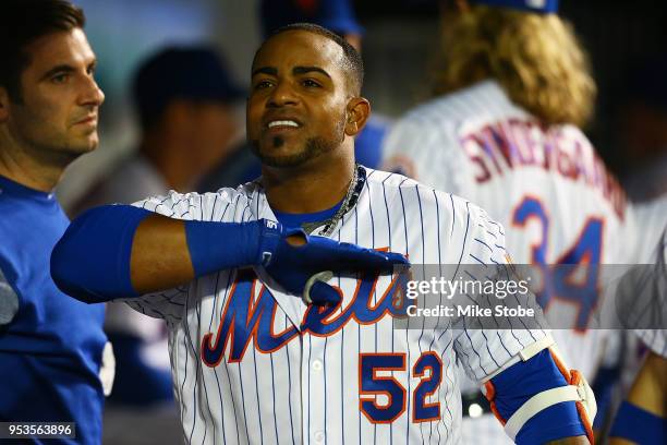Yoenis Cespedes of the New York Mets celebrates in the dugout after hitting a solo home run in the sixth inning against the Atlanta Braves at Citi...