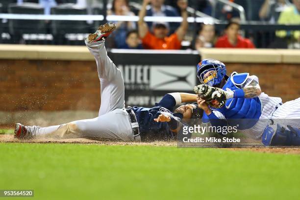 Kurt Suzuki of the Atlanta Braves is tagged out at home by Tomas Nido of the New York Mets trying to score on a Ryan Flaherty single in the seventh...