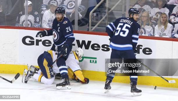 Blake Wheeler of the Winnipeg Jets looks up after taking a penalty against Mattias Ekholm of the Nashville Predators in Game Three of the Western...