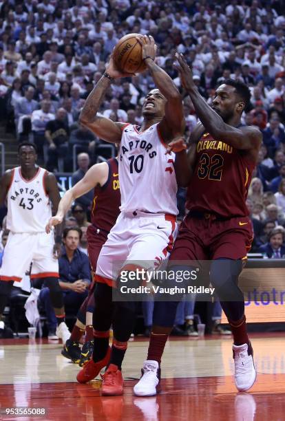 DeMar DeRozan of the Toronto Raptors shoots the ball as Jeff Green of the Cleveland Cavaliers defends in the first half of Game One of the Eastern...