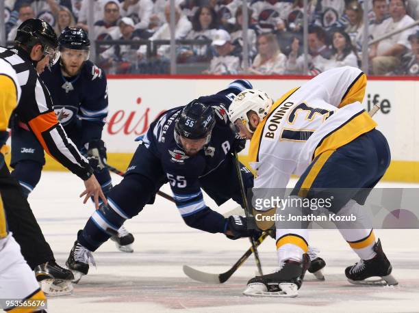 Mark Scheifele of the Winnipeg Jets takes a first period face-off against Nick Bonino of the Nashville Predators in Game Three of the Western...