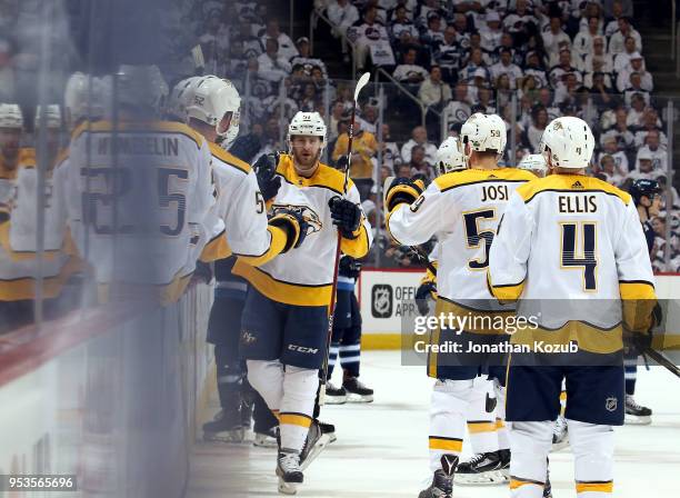 Austin Watson of the Nashville Predators celebrates his first period goal against the Winnipeg Jets with teammates at the bench in Game Three of the...