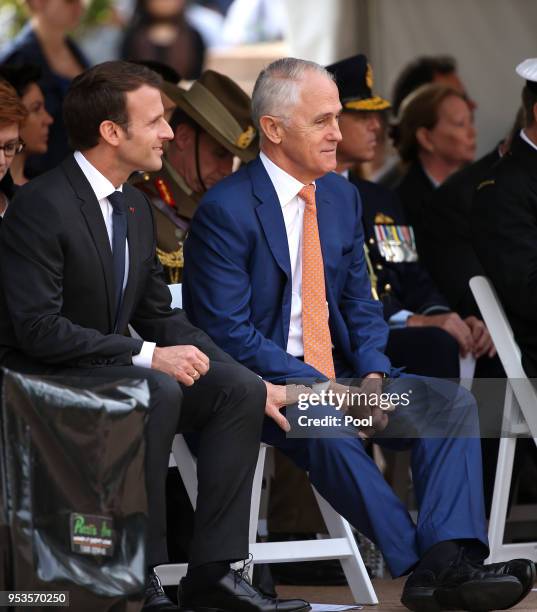 French President Emmanuel Macron grips the leg of Australian Prime Minister Malcolm Turnbull during war commemorative ceremony on May 2, 2018 in...