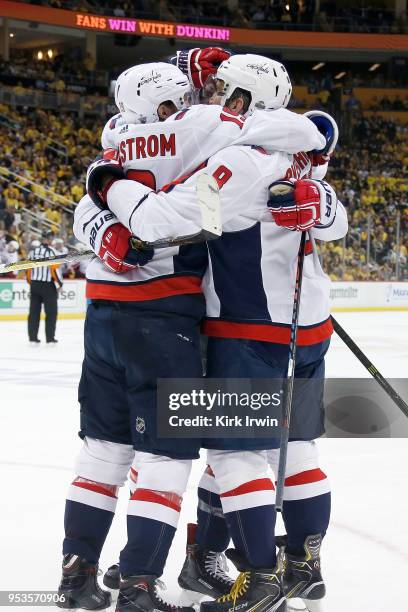 Alex Ovechkin of the Washington Capitals is congratulated by his teammates after scoring the game winning goal during the third period in Game Three...