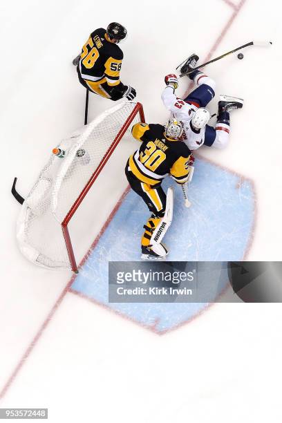 Matt Murray of the Pittsburgh Penguins blocks the net as Tom Wilson of the Washington Capitals attempts to keep control of the puck as Kris Letang of...