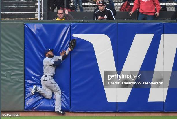 Manuel Margot of the San Diego Padres collides with the wall while taking a hit a way from Andrew McCutchen of the San Francisco Giants in the bottom...
