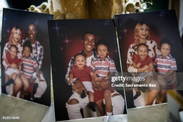 Pictures showing Stephon Clark and his wife Salena Manni, and sons Aiden Clark and Cairo Clark rested on a table inside his grandmother Sequita...