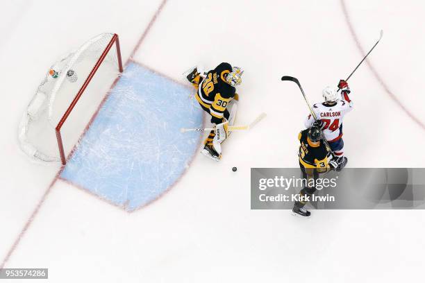 Matt Murray of the Pittsburgh Penguins makes a save as Olli Maatta of the Pittsburgh Penguins attempts to keep John Carlson of the Washington...