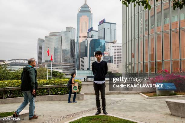 This picture taken on April 17, 2018 shows disqualified pro-independence lawmaker Baggio Leung posing near the Legislative Council in Hong Kong. - It...