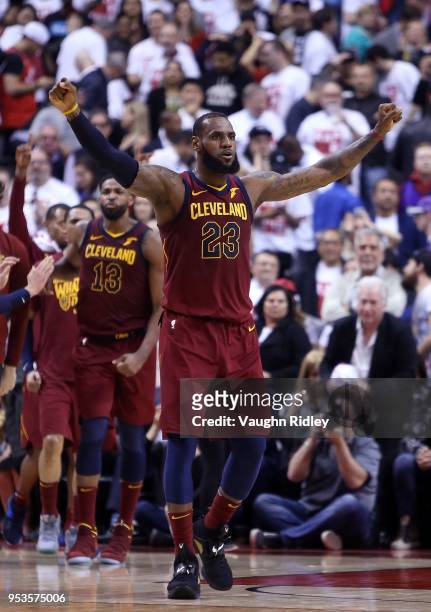 LeBron James of the Cleveland Cavaliers celebrates in overtime in Game One of the Eastern Conference Semifinals against the Toronto Raptors during...