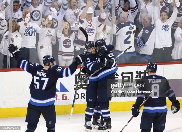 Mark Scheifele congratulates Blake Wheeler of the Winnipeg Jets on his empty-net goal against the Nashville Predators in Game Three of the Western...