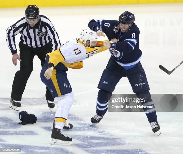 Jacob Trouba of the Winnipeg Jets fights Nick Bonino of the Nashville Predators in Game Three of the Western Conference Second Round during the 2018...