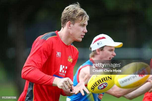 Tom Lynch handballs during a Gold Coast Suns AFL training session on May 2, 2018 in Gold Coast, Australia.