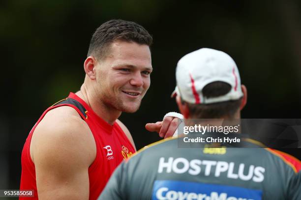 Steven May and Coach Stuart Dew talk during a Gold Coast Suns AFL training session on May 2, 2018 in Gold Coast, Australia.