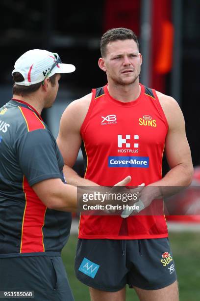 Steven May and Coach Stuart Dew talk during a Gold Coast Suns AFL training session on May 2, 2018 in Gold Coast, Australia.