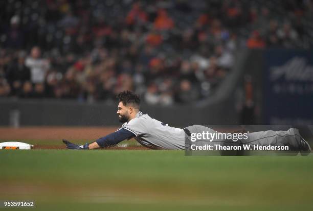 Eric Hosmer of the San Diego Padres dives into third base with a triple against the San Francisco Giants in the top of the fourth inning at AT&T Park...