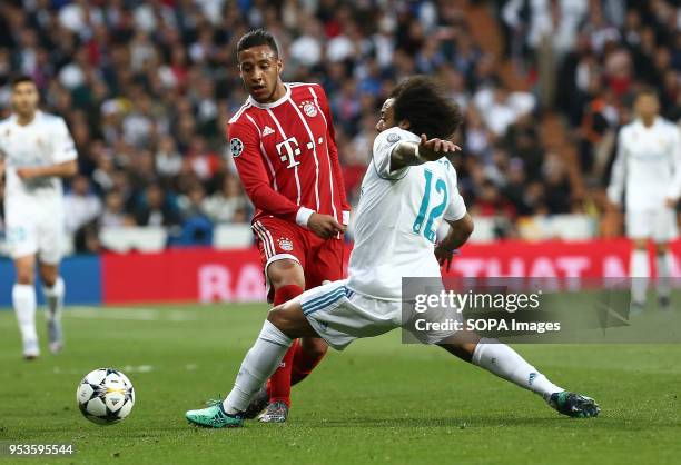 Corentin Tolisso competes for the ball with Marcelo during the UEFA Champions League Semi Final Second Leg match between Real Madrid and Bayern...