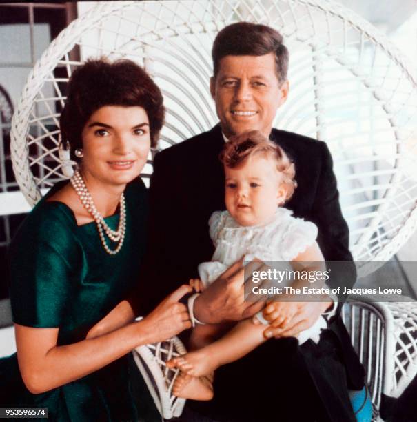 Portrait of married couple Jacqueline Kennedy and Senator John F Kennedy as they pose with their daughter Caroline, Hyannis Port, Massachusetts,...