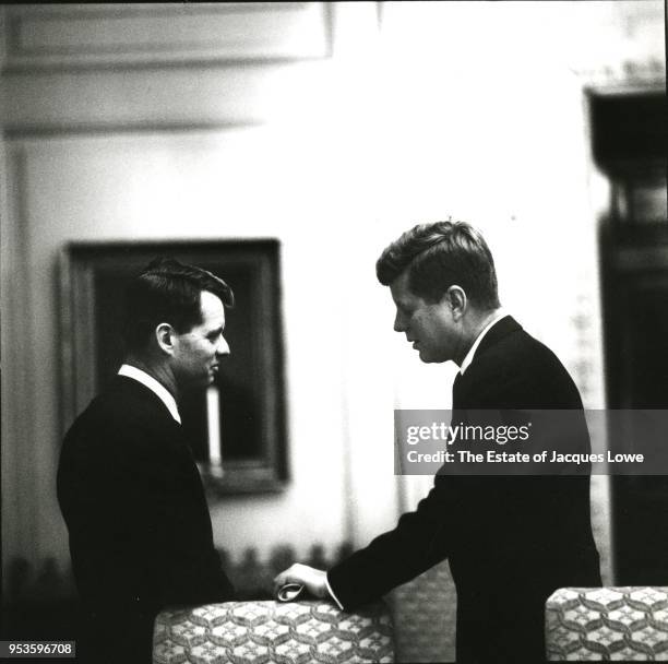 View of US Attorney General Robert F Kennedy and his brother, US President John F Kennedy , as they talk in the White House, Washington DC, early...