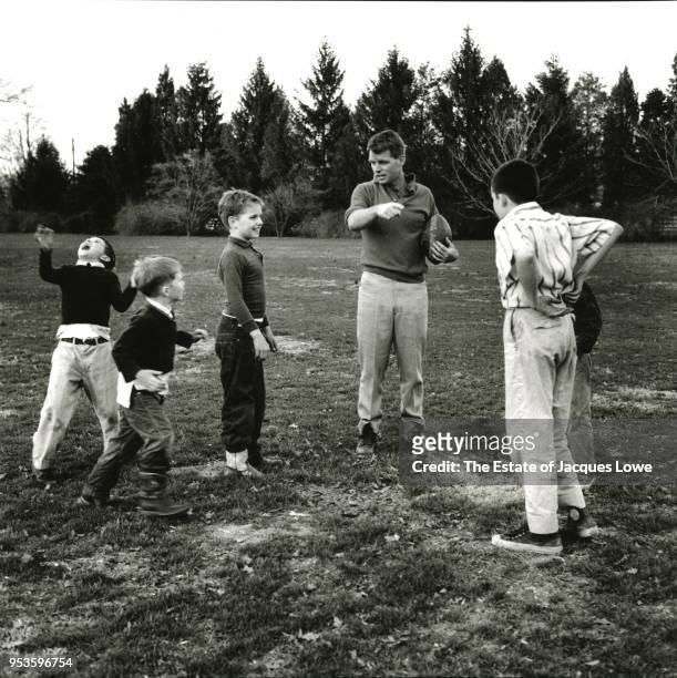 During a football game, US Attorney General Robert F Kennedy points out something to his team, made up of various Kennedy and neighborhood children,...