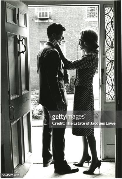 View of American lawyer Ted Kennedy and his wife, Joan Bennett Kennedy, as they smile at one another in the doorway of their home, 1960s.