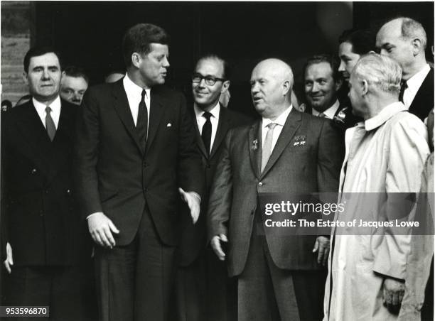 Surrounded by staffers, US President John F Kennedy and Soviet Premier Nikita Khrushchev speak on the steps outside American Embassy, Vienna,...