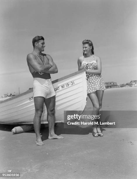 COUPLE STANDING NEAR BOAT