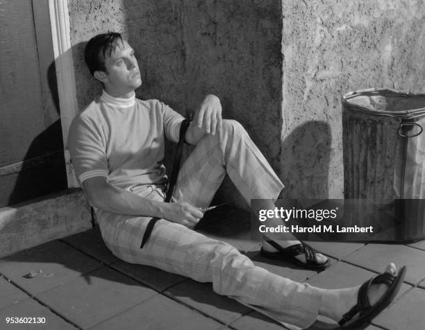 ADDICTED YOUNG MAN TAKING DRUGS WITH SYRINGE