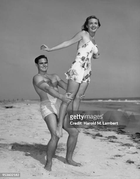 YOUNG COUPLE ENJOYING THE BEACH